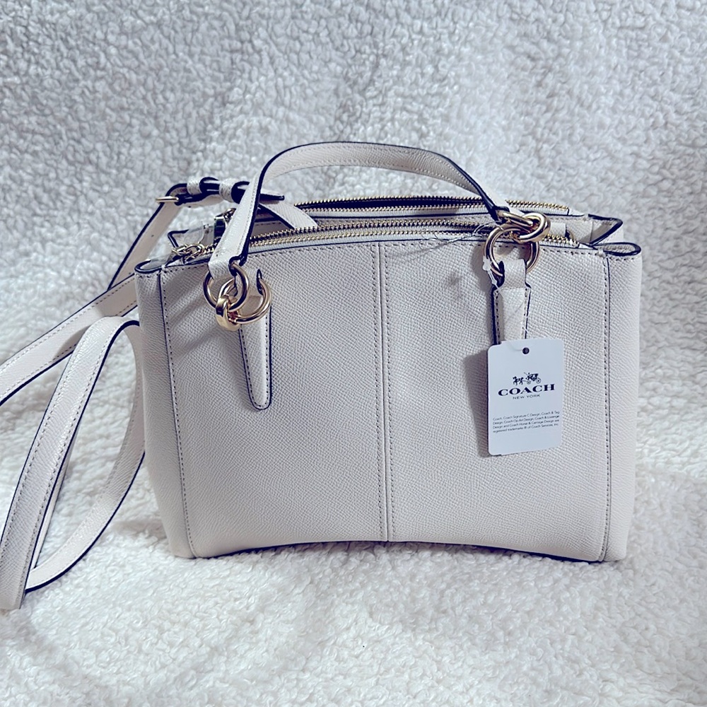 Coach bag leader bag with gold handles. Luxury item.